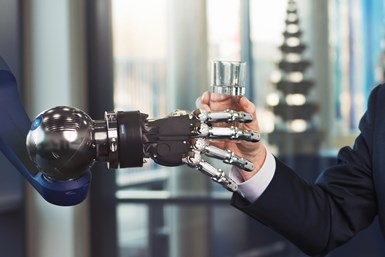 Five-fingered robot gripper handing a person a glass of water